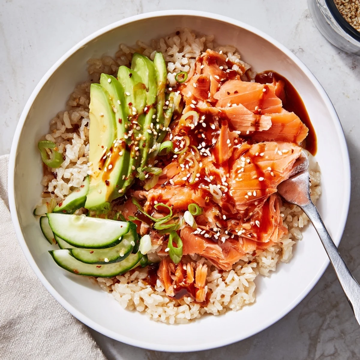 Quick microwave-steamed salmon and rice bowl, garnished with sesame seeds and pickled ginger.  