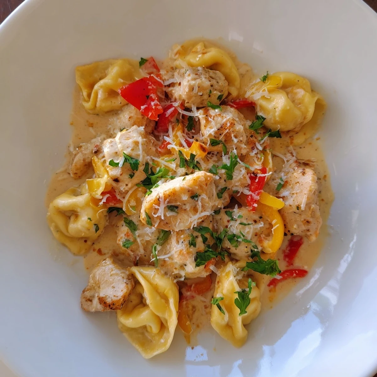 Creamy Zesty Cajun Garlic Parmesan Chicken Tortellini, a flavorful pasta dish with vibrant red pepper chunks.