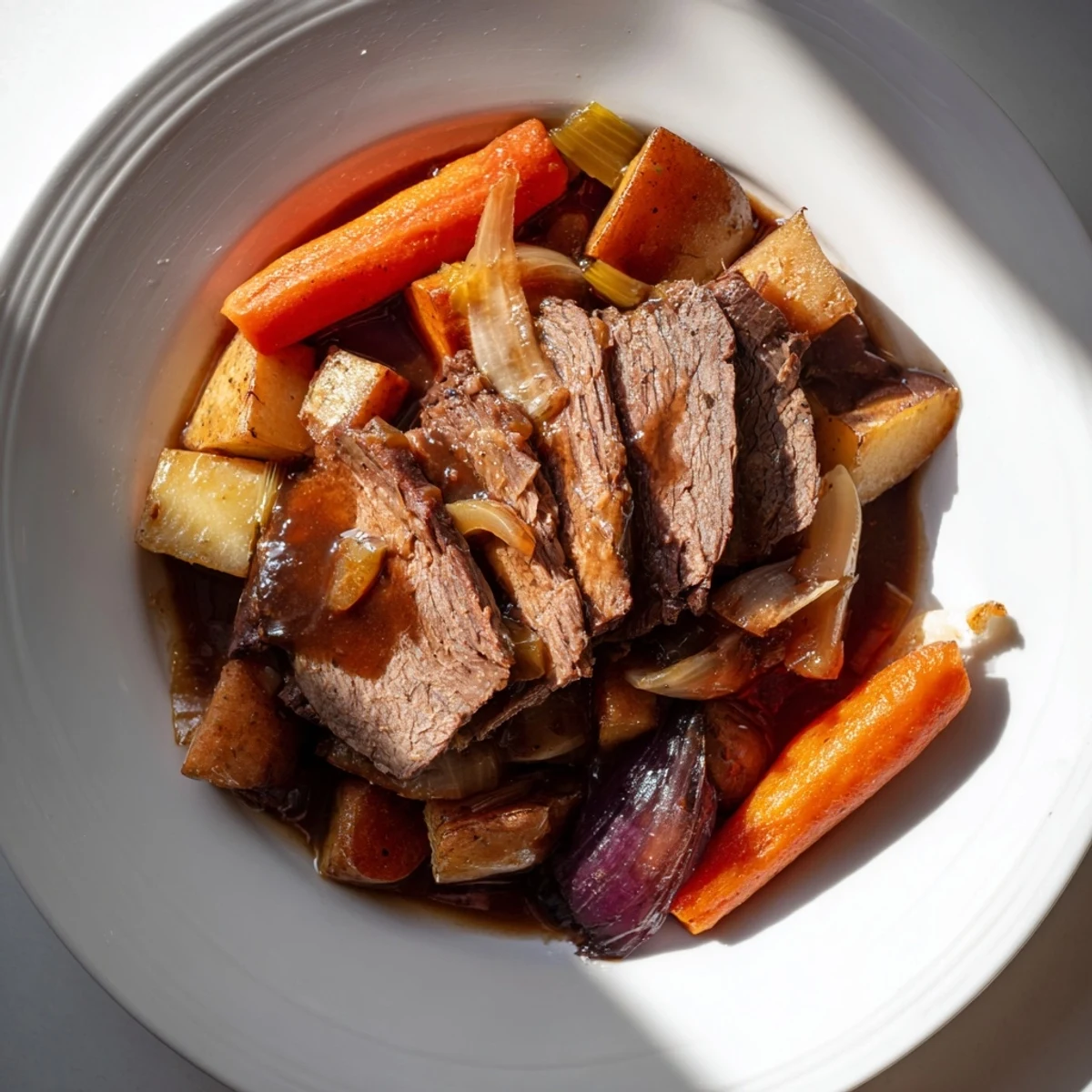 Close up shot of a delicious Sunday Pot Roast, brimming with fall-apart beef and tender roasted veggies.