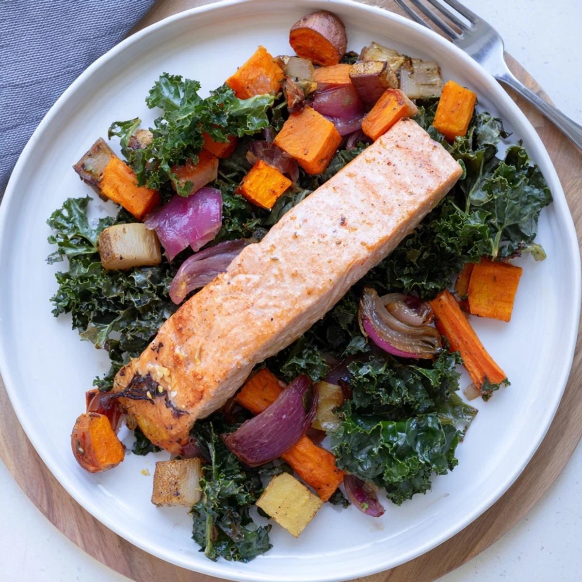 Golden-brown sheet-pan salmon with roasted winter vegetables, a flavorful and easy meal.