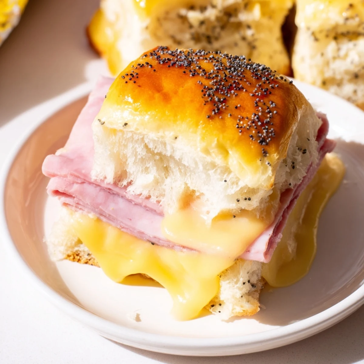 Baked Ham and Cheese Party Sliders, golden and melty, perfect for a satisfying appetizer for any party.
