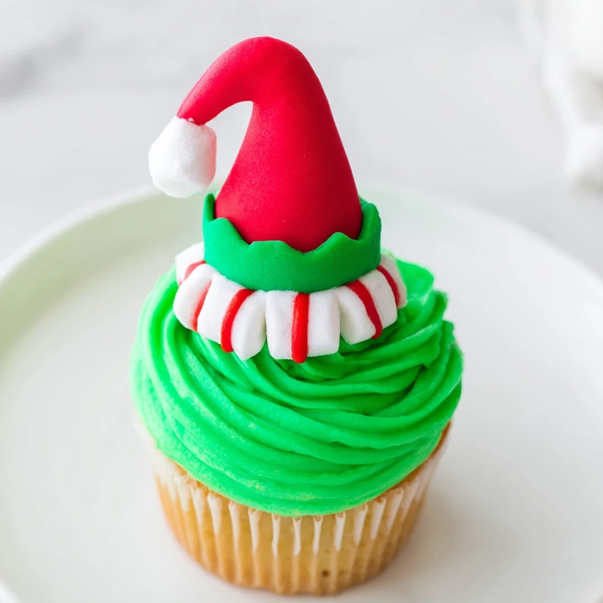 Festive image: a colorful Elf Hat Cupcake Tower, perfect for holiday celebrations and treats.