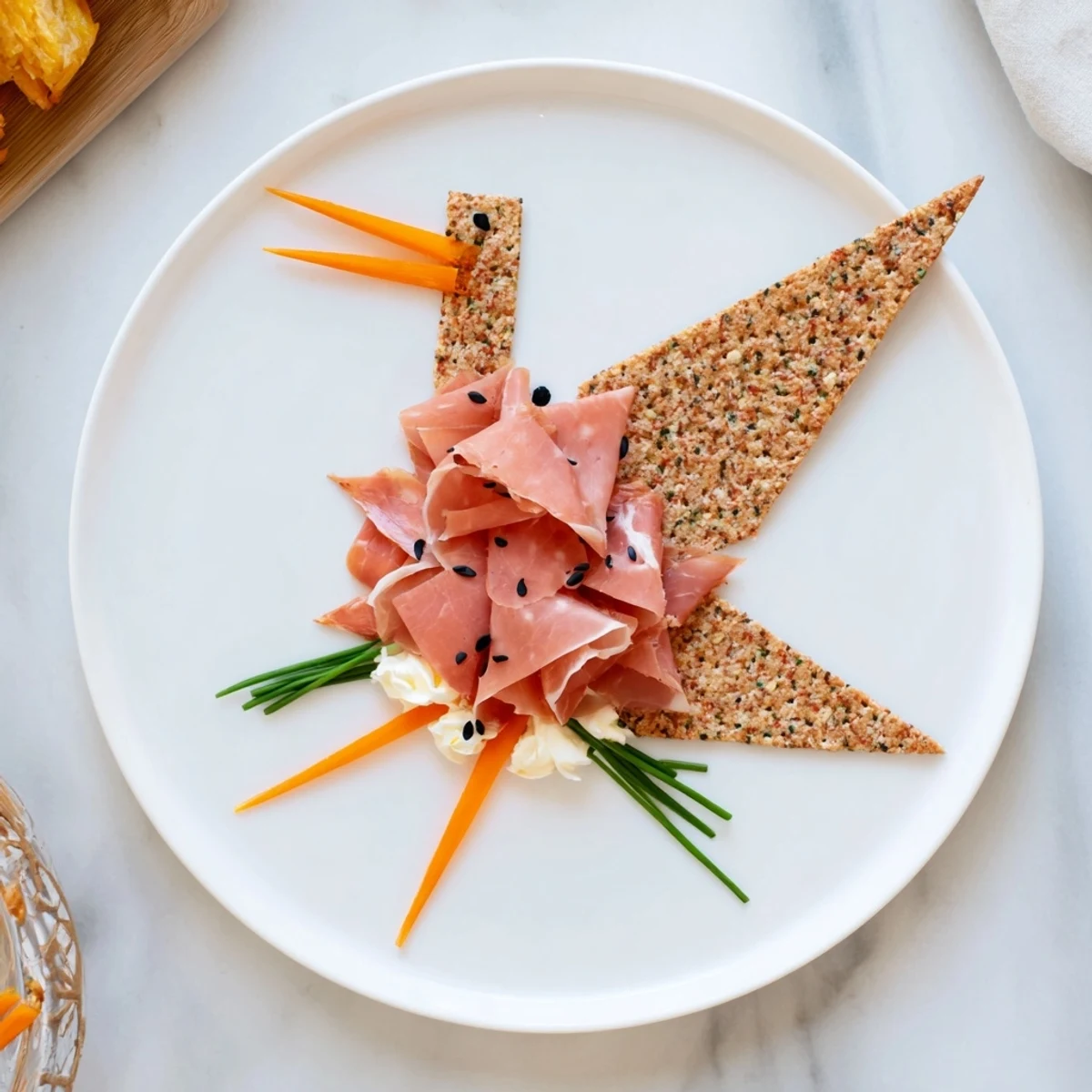 Elegant arrangement of The Paper Crane appetizer, featuring folded cured meats and contrasting crackers.