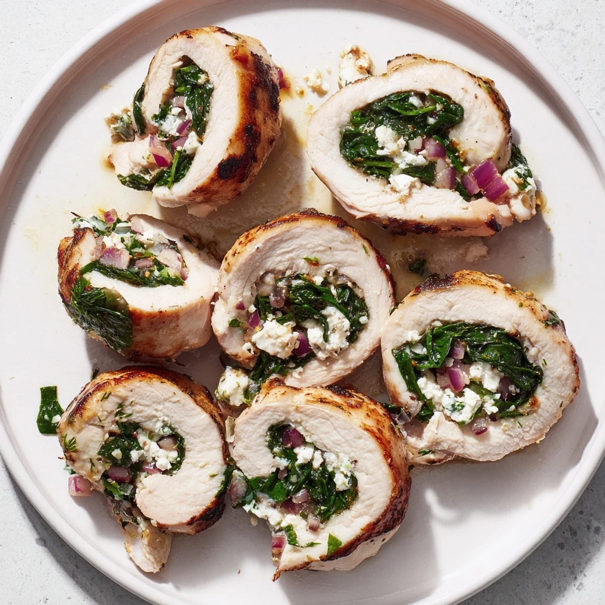 Golden-brown, rolled spinach feta stuffed chicken, ready to be sliced and enjoyed.
