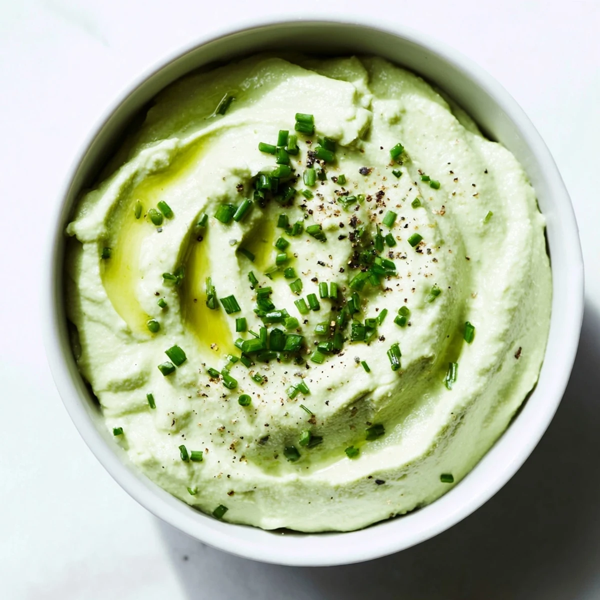 Creamy Avocado Cottage Cheese Dip, a vibrant green dip ready to be scooped up with veggies.