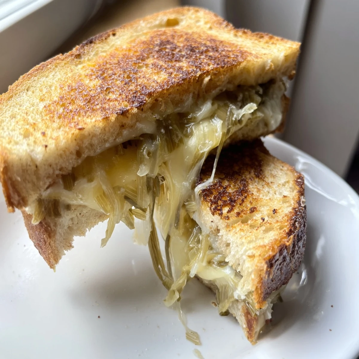Perfectly melty Havarti cheese and tender caramelized leeks make this Havarti & Caramelized Leek Grilled Cheese a cozy lunch.