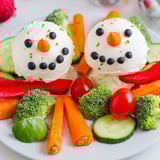 A festive Snowman Veggie Dip Platter, perfect for a cheerful holiday appetizer with colorful crudités.