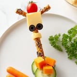A delicious close-up of the fun Long-Necked Giraffe Snack Tower, featuring pretzel neck and cheese spots.