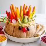 A visually appealing Autumn Hedgehog Dip Platter, with creamy textures and fresh veggies ready for dipping.