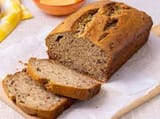 Classic banana bread with a crackly top, cooling on a wire rack at home