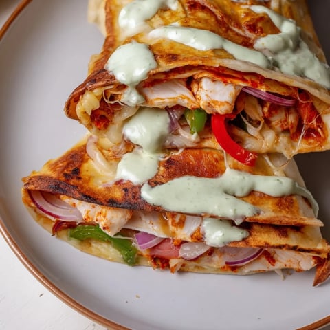Golden-brown Tandoori Chicken Quesadilla shows the melty cheese and tender chicken filling ready for a flavorful bite.