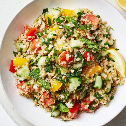 Fresh, vibrant Tabbouleh Grain Bowl, overflowing with colorful veggies and a bright lemon dressing.