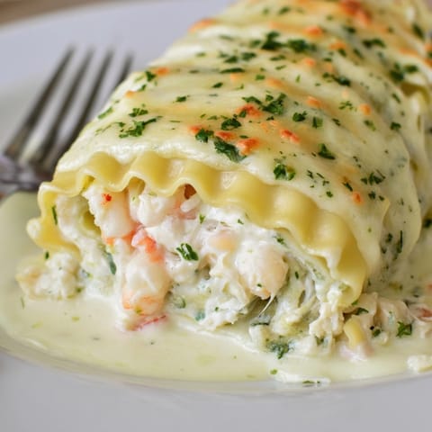 Rich, creamy Shrimp Alfredo Lasagna Rolls with melted mozzarella, a decadent seafood pasta.