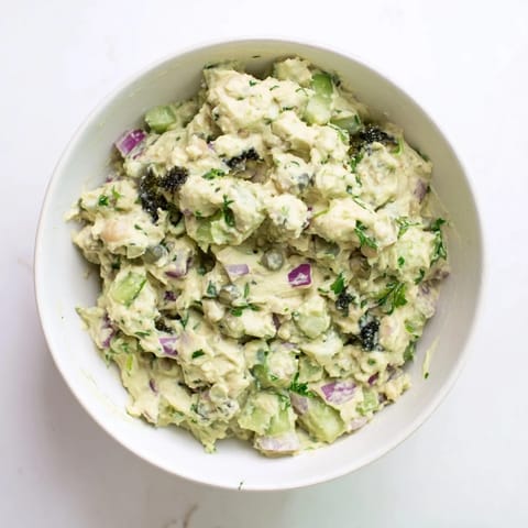 Mashed chickpea tuna salad, a colorful mix with diced vegetables, perfect for sandwiches or a wrap.