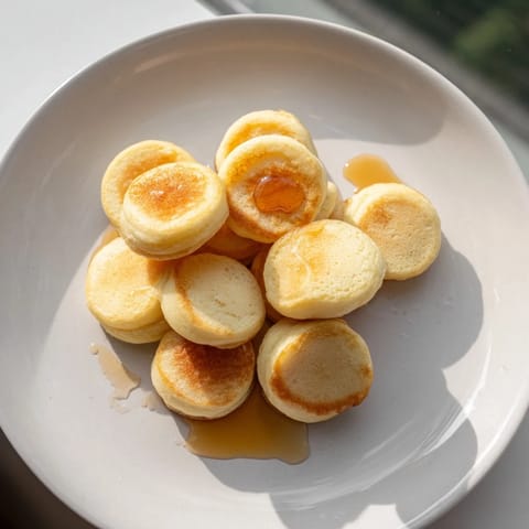Tiny, fluffy pancake cereal, swimming in milk and ready for drizzling with maple syrup.