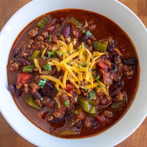 Fragrant, hearty quick chili simmering, showing a rich red color from tomatoes and spices.