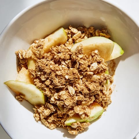 A fresh-baked Best Apple Crisp, showcasing a delicious oat-almond crumble topping over tender apples.