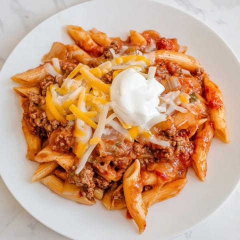 This delicious close-up highlights steamy Easy Beef Enchilada Pasta with pasta and ground beef.