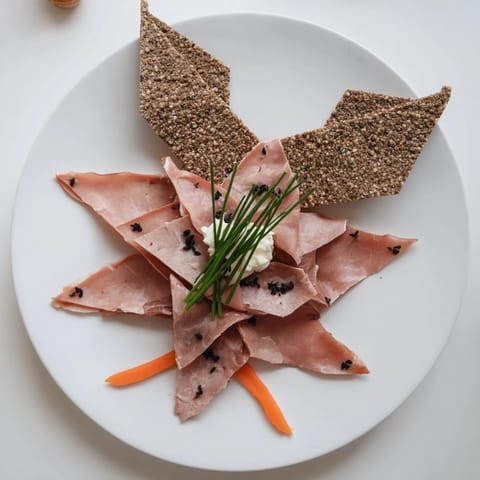 Crisp crackers and delicate meats form a beautiful The Paper Crane, ready for your next party.