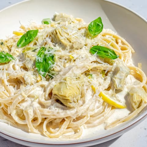 Bright, creamy texture of the Creamy Lemon Artichoke Pasta with tender artichokes and fresh lemon.