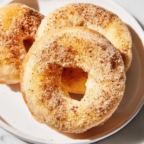 Fluffy and warm, these 1-Minute Air Fryer Donuts are a quick American dessert delight.