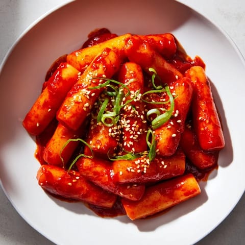 A close-up of piping hot Korean Tteokbokki, offering a blend of savory and delightful spicy flavors in every bite.