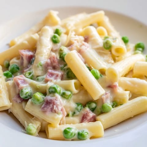 Spring Pea & Ham Pasta with bright green peas and savory ham tossed in a rich cream sauce over penne.