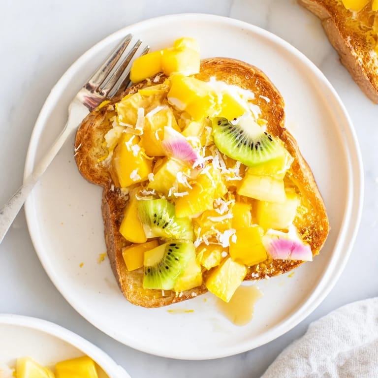 Deliciously golden Yogurt-Custard Toast 2.0 with coconut yogurt and colorful fruit toppings.  