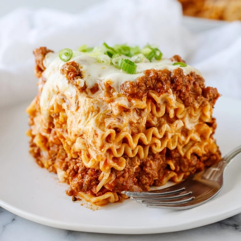 Mouthwatering Spicy Ramen Lasagna featuring rich meat sauce and creamy ricotta layers.