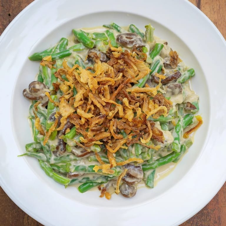 A comforting photo of creamy Old-School Green Bean Casserole, showcasing tender green beans in a rich mushroom sauce.
