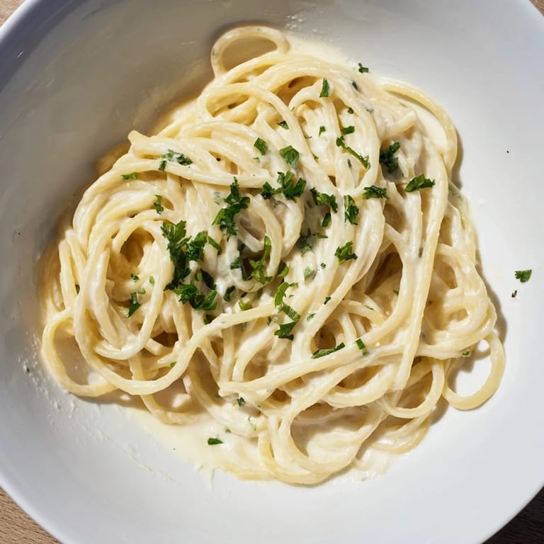 A close-up of Creamy Three-Cheese Spaghetti with melted cheese, ready for a delicious dinner.