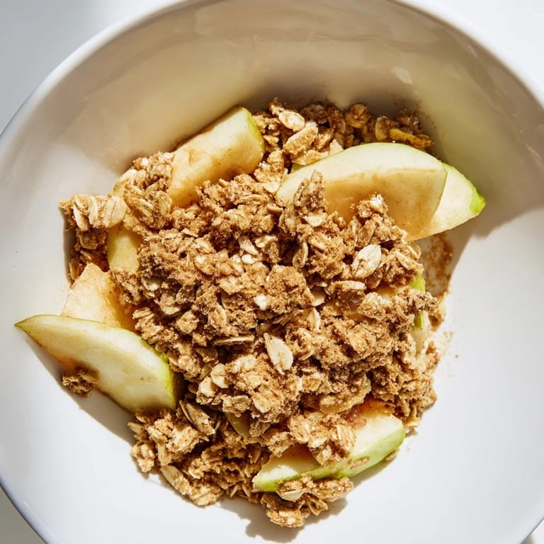 A fresh-baked Best Apple Crisp, showcasing a delicious oat-almond crumble topping over tender apples.