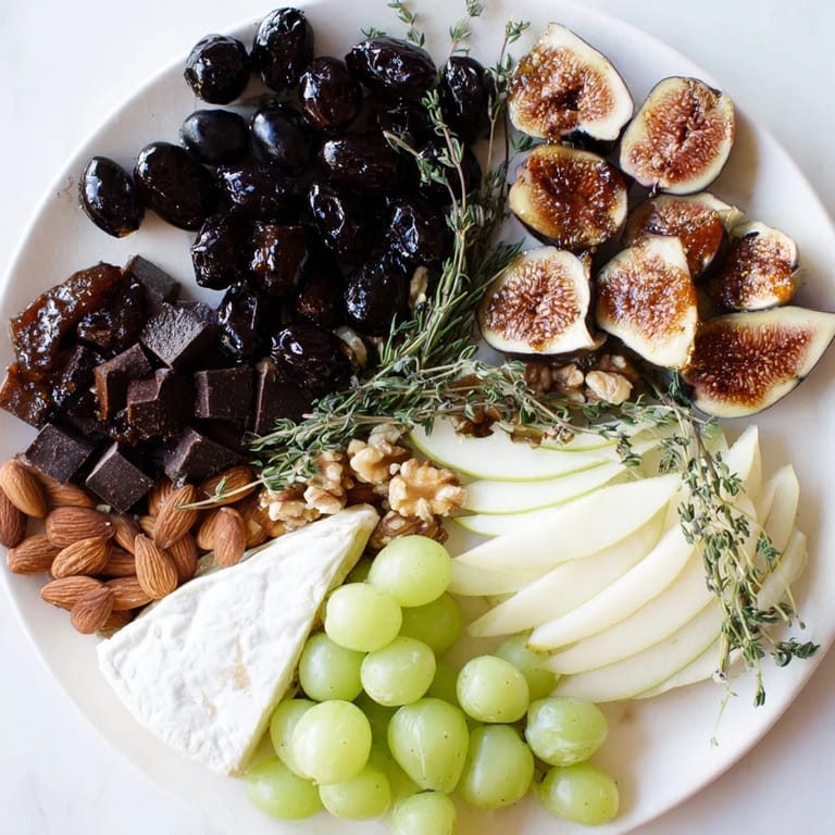 Artfully arranged Winter Solstice Board, offering savory olives and sweet figs alongside creamy Brie.
