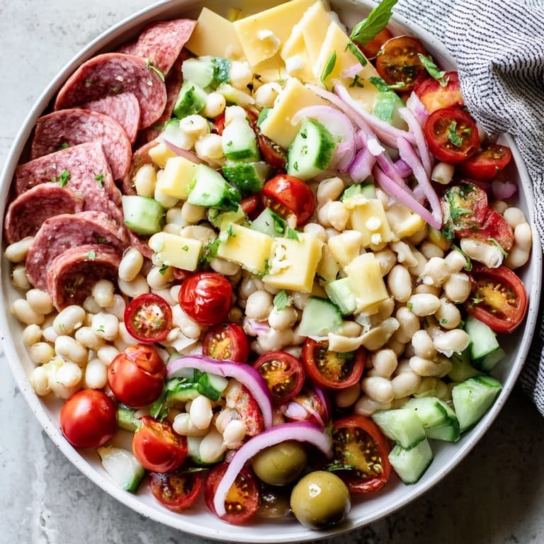 Delicious Italian Antipasto Bean Salad, showcasing salami, provolone, and a vibrant zesty dressing for a flavorful appetizer.